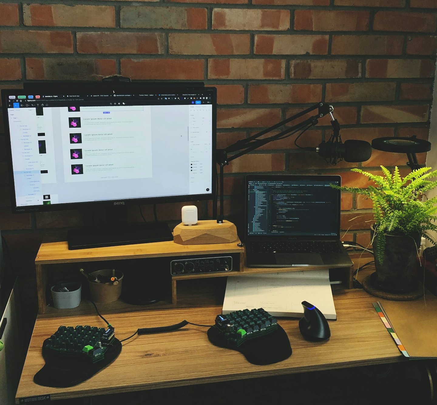 Tech workstation with monitors and gear on a wooden desk.