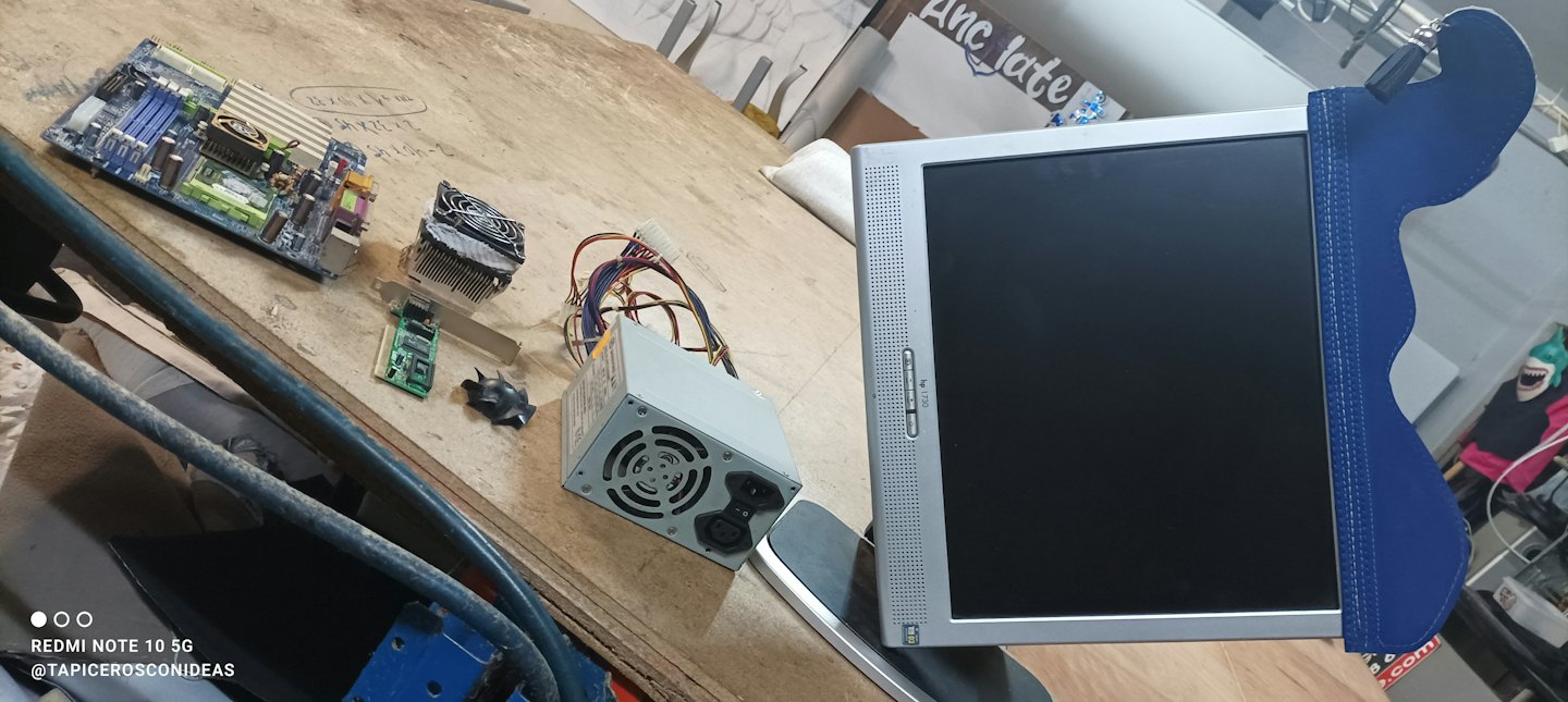 Disassembled computer parts laid out on a wooden workbench.